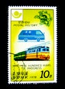 A stamp printed in North Korea shows an image of a blue postal van and train for Postal history 1874-1974 Hundred years.